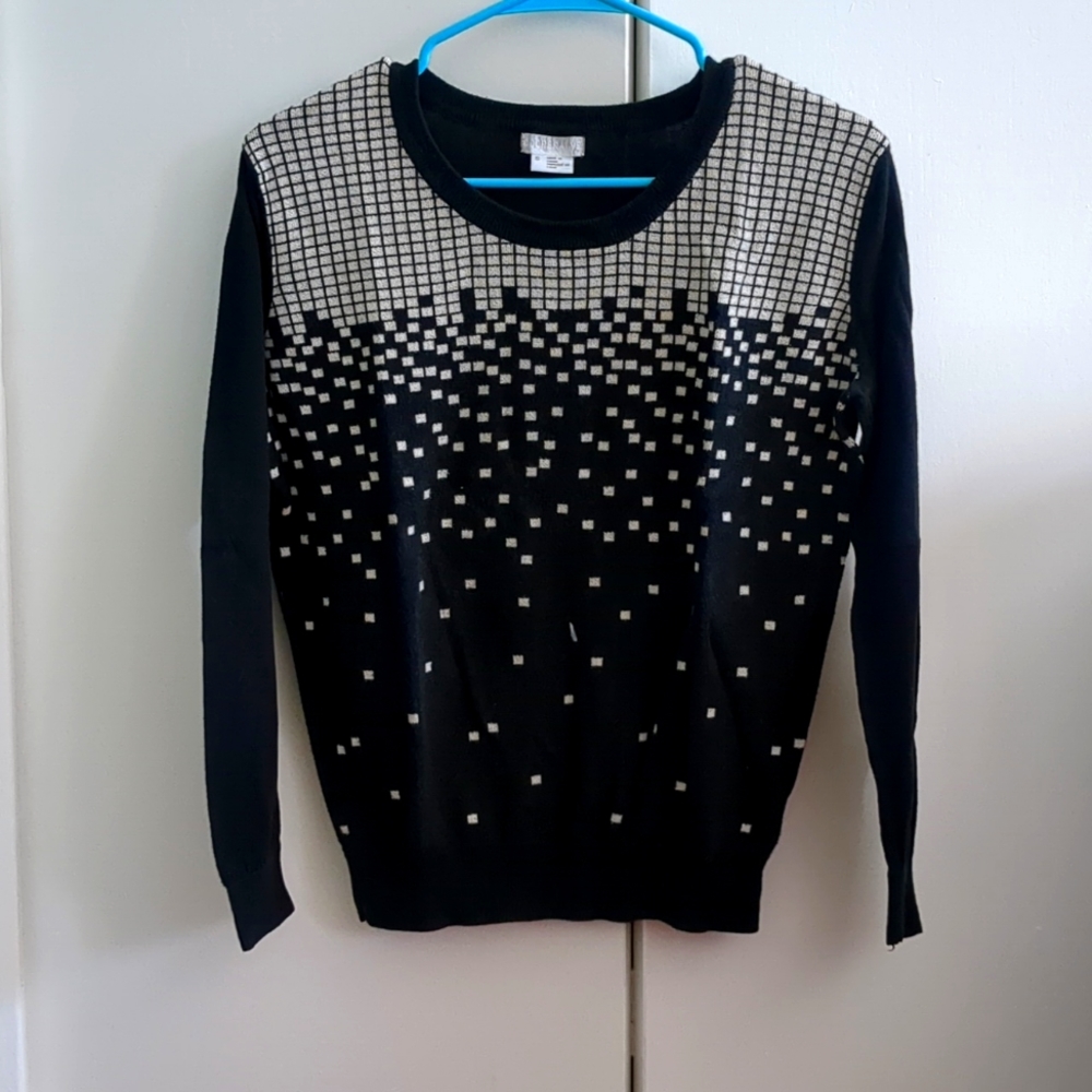 Black crewneck sweater with white square pattern.